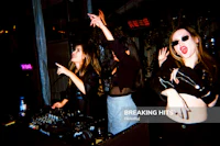three women at a party with a dj - stock photo