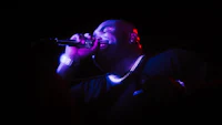a man is singing into a microphone
