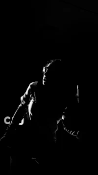 a silhouette of a woman in a dark room