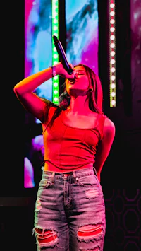 a woman singing into a microphone